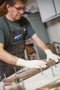 Jay laminates wood for structural strength.